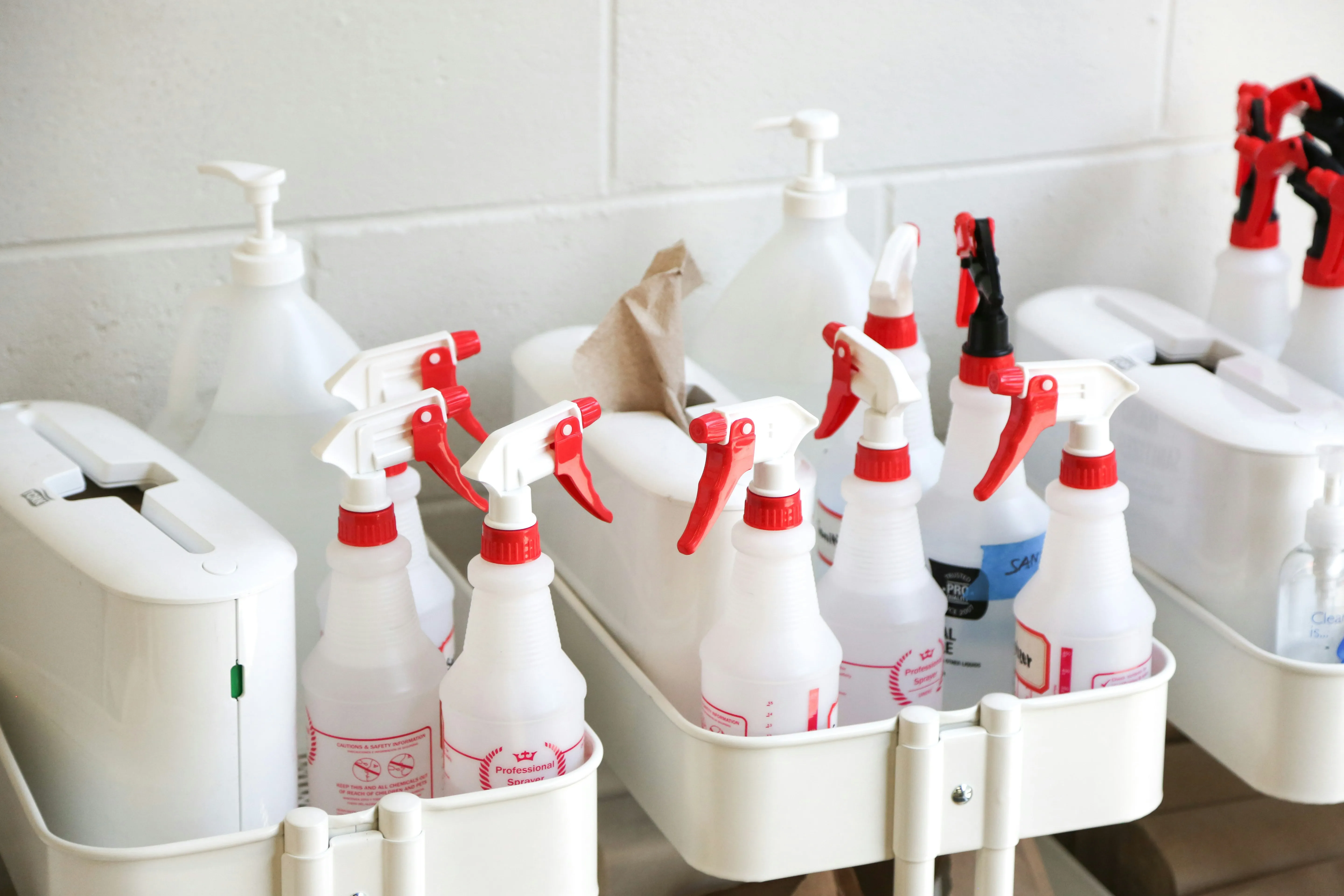 A caddy of professional cleaning supplies